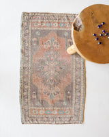 Vintage Turkish mini rug in room decor setting, old rug, antique rug, pastel colors, faded colors, Turkish rug, vintage rug, soft rug, Portland, Oregon, rug store, rug shop, local shop