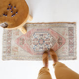Vintage Turkish mini rug in room decor setting, old rug, antique rug, pastel colors, faded colors, Turkish rug, vintage rug, soft rug, Portland, Oregon, rug store, rug shop, local shop