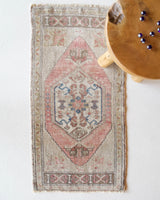 Vintage Turkish mini rug in room decor setting, old rug, antique rug, pastel colors, faded colors, Turkish rug, vintage rug, soft rug, Portland, Oregon, rug store, rug shop, local shop