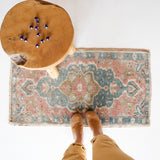 Vintage Turkish mini rug in room decor setting, old rug, antique rug, pastel colors, faded colors, Turkish rug, vintage rug, soft rug, Portland, Oregon, rug store, rug shop, local shop