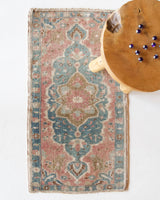 Vintage Turkish mini rug in room decor setting, old rug, antique rug, pastel colors, faded colors, Turkish rug, vintage rug, soft rug, Portland, Oregon, rug store, rug shop, local shop