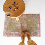 Vintage Turkish mini rug in room decor setting, old rug, antique rug, pastel colors, faded colors, Turkish rug, vintage rug, soft rug, Portland, Oregon, rug store, rug shop, local shop