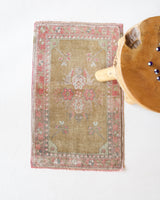 Vintage Turkish mini rug in room decor setting, old rug, antique rug, pastel colors, faded colors, Turkish rug, vintage rug, soft rug, Portland, Oregon, rug store, rug shop, local shop