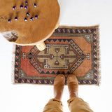Vintage Turkish mini rug in room decor setting, old rug, antique rug, pastel colors, faded colors, Turkish rug, vintage rug, soft rug, Portland, Oregon, rug store, rug shop, local shop