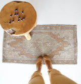 Vintage Turkish mini rug in room decor setting, old rug, antique rug, pastel colors, faded colors, Turkish rug, vintage rug, soft rug, Portland, Oregon, rug store, rug shop, local shop