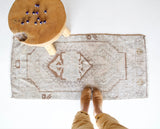 Vintage Turkish mini rug in room decor setting, old rug, antique rug, pastel colors, faded colors, Turkish rug, vintage rug, soft rug, Portland, Oregon, rug store, rug shop, local shop