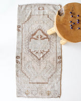 Vintage Turkish mini rug in room decor setting, old rug, antique rug, pastel colors, faded colors, Turkish rug, vintage rug, soft rug, Portland, Oregon, rug store, rug shop, local shop