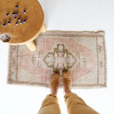 Vintage Turkish mini rug in room decor setting, old rug, antique rug, pastel colors, faded colors, Turkish rug, vintage rug, soft rug, Portland, Oregon, rug store, rug shop, local shop