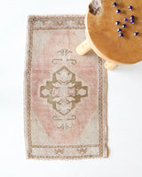Vintage Turkish mini rug in room decor setting, old rug, antique rug, pastel colors, faded colors, Turkish rug, vintage rug, soft rug, Portland, Oregon, rug store, rug shop, local shop