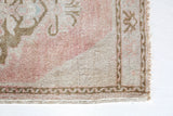 Vintage Turkish mini rug in room decor setting, old rug, antique rug, pastel colors, faded colors, Turkish rug, vintage rug, soft rug, Portland, Oregon, rug store, rug shop, local shop