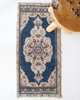 Vintage Turkish mini rug in room decor setting, old rug, antique rug, pastel colors, faded colors, Turkish rug, vintage rug, soft rug, Portland, Oregon, rug store, rug shop, local shop