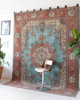 Area rug in a living room setting, pile rug, Turkish rug, old rug, antique rug, pastel colors, faded colors, Turkish rug, vintage rug, soft rug, Portland, Oregon, rug store, rug shop, local shop