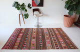 Vintage kilim rug in room decor setting, kilim, Turkish rug, vintage rug, portland, rug shop, bright colors, wild shaman, soft rug, bold color, Portland, Oregon, rug store, rug shop, local shop, antique rug