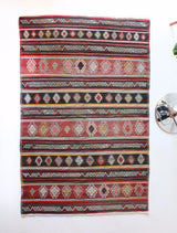 Vintage kilim rug in room decor setting, old rug, antique rug, pastel colors, faded colors, Turkish rug, vintage rug, soft rug, Portland, Oregon, rug store, rug shop, local shop