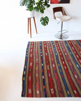 Vintage kilim rug in room decor setting, old rug, antique rug, pastel colors, faded colors, Turkish rug, vintage rug, soft rug, Portland, Oregon, rug store, rug shop, local shop