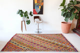 Vintage kilim rug in room decor setting, kilim, Turkish rug, vintage rug, portland, rug shop, bright colors, wild shaman, soft rug, bold color, Portland, Oregon, rug store, rug shop, local shop, antique rug