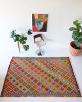 Vintage kilim rug in room decor setting, kilim, Turkish rug, vintage rug, portland, rug shop, bright colors, wild shaman, soft rug, bold color, Portland, Oregon, rug store, rug shop, local shop, antique rug