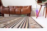 Vintage kilim rug in room decor setting, old rug, antique rug, pastel colors, faded colors, Turkish rug, vintage rug, soft rug, Portland, Oregon, rug store, rug shop, local shop, distressed rug, worn out rug