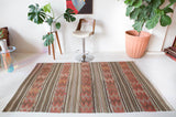 Vintage kilim rug in room decor setting, old rug, antique rug, pastel colors, faded colors, Turkish rug, vintage rug, soft rug, Portland, Oregon, rug store, rug shop, local shop, distressed rug, worn out rug