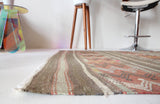 Vintage kilim rug in room decor setting, old rug, antique rug, pastel colors, faded colors, Turkish rug, vintage rug, soft rug, Portland, Oregon, rug store, rug shop, local shop, distressed rug, worn out rug