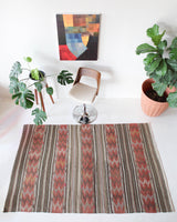 Vintage kilim rug in room decor setting, old rug, antique rug, pastel colors, faded colors, Turkish rug, vintage rug, soft rug, Portland, Oregon, rug store, rug shop, local shop, distressed rug, worn out rug