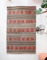 Vintage kilim rug in room decor setting, old rug, antique rug, pastel colors, faded colors, Turkish rug, vintage rug, soft rug, Portland, Oregon, rug store, rug shop, local shop, distressed rug, worn out rug