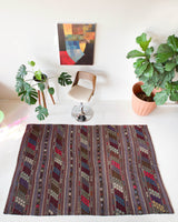 Vintage kilim rug in room decor setting, old rug, antique rug, pastel colors, faded colors, Turkish rug, vintage rug, soft rug, Portland, Oregon, rug store, rug shop, local shop, distressed rug, worn out rug