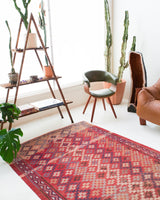 Vintage kilim rug in room decor setting, old rug, antique rug, pastel colors, faded colors, Turkish rug, vintage rug, soft rug, Portland, Oregon, rug store, rug shop, local shop, distressed rug, worn out rug