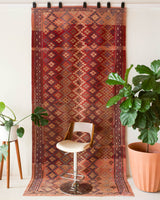 Vintage kilim rug in room decor setting, old rug, antique rug, pastel colors, faded colors, Turkish rug, vintage rug, soft rug, Portland, Oregon, rug store, rug shop, local shop, distressed rug, worn out rug