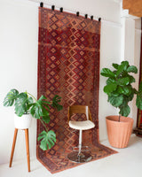 Vintage kilim rug in room decor setting, old rug, antique rug, pastel colors, faded colors, Turkish rug, vintage rug, soft rug, Portland, Oregon, rug store, rug shop, local shop, distressed rug, worn out rug