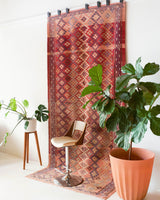 Vintage kilim rug in room decor setting, old rug, antique rug, pastel colors, faded colors, Turkish rug, vintage rug, soft rug, Portland, Oregon, rug store, rug shop, local shop, distressed rug, worn out rug