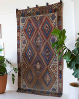 Vintage kilim rug in living room setting, old rug, antique rug, pastel colors, faded colors, Turkish rug, vintage rug, soft rug, Portland, Oregon, rug store, rug shop, local shop, earthy tones, earthy colors, warm colors