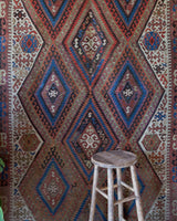 Vintage kilim rug in living room setting, old rug, antique rug, pastel colors, faded colors, Turkish rug, vintage rug, soft rug, Portland, Oregon, rug store, rug shop, local shop, earthy tones, earthy colors, warm colors
