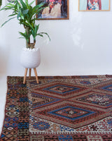 Vintage kilim rug in living room setting, old rug, antique rug, pastel colors, faded colors, Turkish rug, vintage rug, soft rug, Portland, Oregon, rug store, rug shop, local shop, earthy tones, earthy colors, warm colors