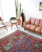 Vintage Turkish rug in living room setting, old rug, antique rug, pastel colors, faded colors, Turkish rug, vintage rug, soft rug, Portland, Oregon, rug store, rug shop, local shop