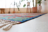 Vintage kilim rug in living room setting, bright colors, wild shaman, soft rug, bold color, Portland, Oregon, rug store, rug shop, local shop, vintage rug, modern kilim, warm colors