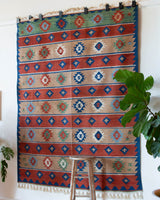 Vintage kilim rug in living room setting, bright colors, wild shaman, soft rug, bold color, Portland, Oregon, rug store, rug shop, local shop, vintage rug, modern kilim, warm colors