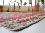 Vintage kilim rug in room decor setting, old rug, antique rug, pastel colors, faded colors, Turkish rug, vintage rug, soft rug, Portland, Oregon, rug store, rug shop, local shop, bold colors, bright colors, faded colors