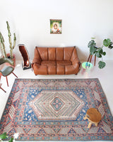 Vintage Turkish rug in living room setting, old rug, antique rug, pastel colors, faded colors, Turkish rug, vintage rug, soft rug, Portland, Oregon, rug store, rug shop, local shop