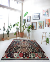 Vintage kilim rug in room decor setting, old rug, antique rug, pastel colors, faded colors, Turkish rug, vintage rug, soft rug, Portland, Oregon, rug store, rug shop, local shop, bold colors, bright colors, faded colors
