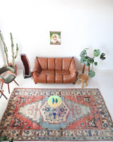 Vintage Turkish rug in living room setting, old rug, antique rug, pastel colors, faded colors, Turkish rug, vintage rug, soft rug, Portland, Oregon, rug store, rug shop, local shop
