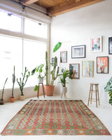 Vintage kilim rug in living room setting, old rug, antique rug, pastel colors, faded colors, Turkish rug, vintage rug, soft rug, Portland, Oregon, rug store, rug shop, local shop, earthy tones, earthy colors, warm colors