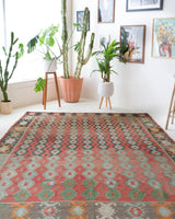 Vintage kilim rug in living room setting, old rug, antique rug, pastel colors, faded colors, Turkish rug, vintage rug, soft rug, Portland, Oregon, rug store, rug shop, local shop, earthy tones, earthy colors, warm colors