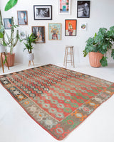 Vintage kilim rug in living room setting, old rug, antique rug, pastel colors, faded colors, Turkish rug, vintage rug, soft rug, Portland, Oregon, rug store, rug shop, local shop, earthy tones, earthy colors, warm colors