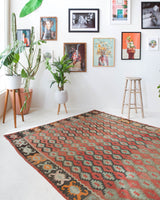Vintage kilim rug in living room setting, old rug, antique rug, pastel colors, faded colors, Turkish rug, vintage rug, soft rug, Portland, Oregon, rug store, rug shop, local shop, earthy tones, earthy colors, warm colors