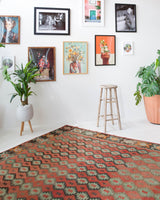 Vintage kilim rug in living room setting, old rug, antique rug, pastel colors, faded colors, Turkish rug, vintage rug, soft rug, Portland, Oregon, rug store, rug shop, local shop, earthy tones, earthy colors, warm colors