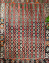 Vintage kilim rug in living room setting, old rug, antique rug, pastel colors, faded colors, Turkish rug, vintage rug, soft rug, Portland, Oregon, rug store, rug shop, local shop, earthy tones, earthy colors, warm colors
