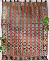 Vintage kilim rug in living room setting, old rug, antique rug, pastel colors, faded colors, Turkish rug, vintage rug, soft rug, Portland, Oregon, rug store, rug shop, local shop, earthy tones, earthy colors, warm colors