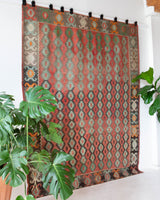 Vintage kilim rug in living room setting, old rug, antique rug, pastel colors, faded colors, Turkish rug, vintage rug, soft rug, Portland, Oregon, rug store, rug shop, local shop, earthy tones, earthy colors, warm colors