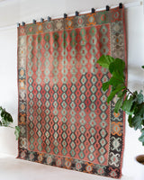 Vintage kilim rug in living room setting, old rug, antique rug, pastel colors, faded colors, Turkish rug, vintage rug, soft rug, Portland, Oregon, rug store, rug shop, local shop, earthy tones, earthy colors, warm colors
